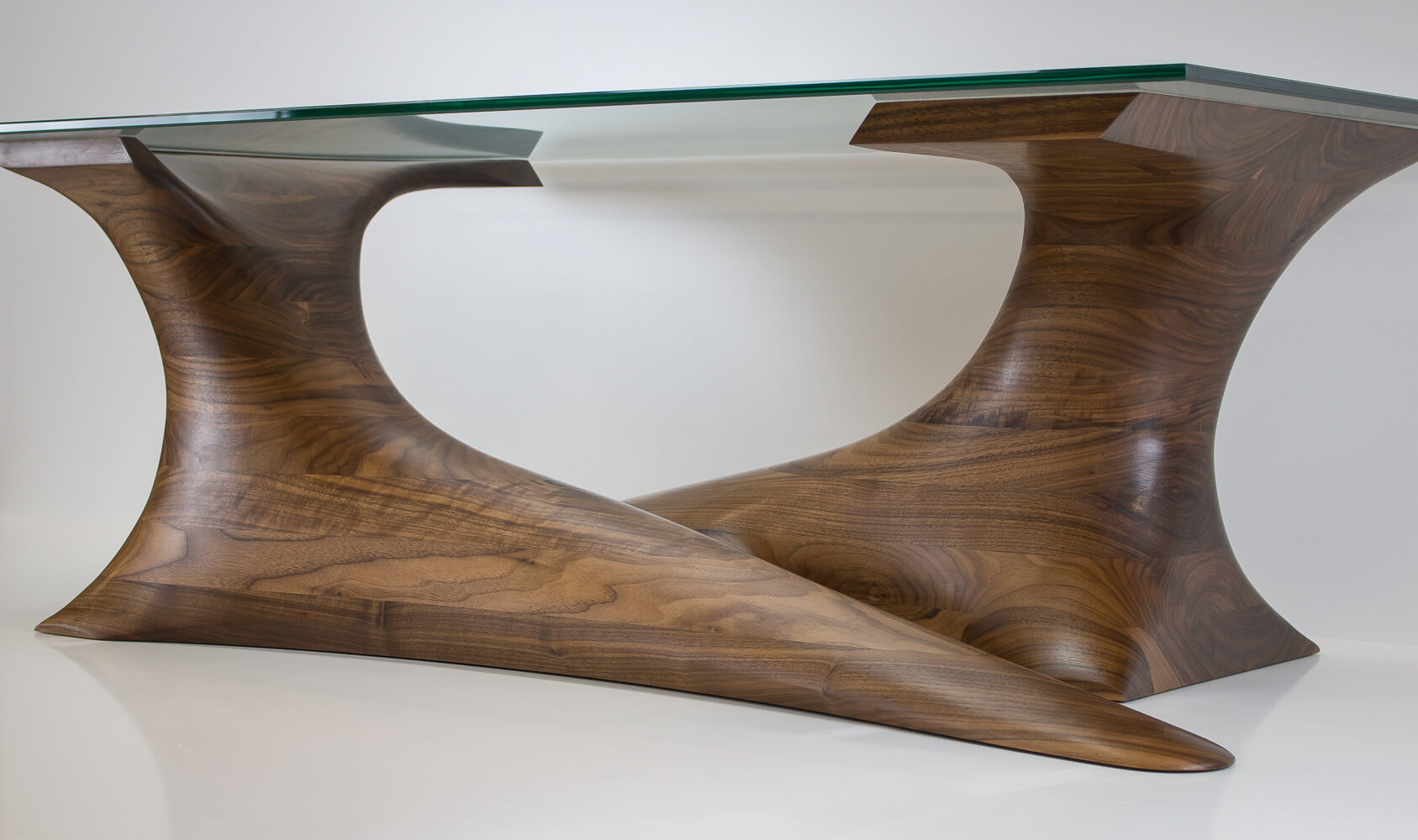 walnut Sculpted coffee table with glass top Pedulla Studio